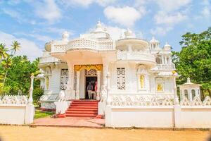 white multi-tiered building old construction, looks lacy. White Buddhist temple photo