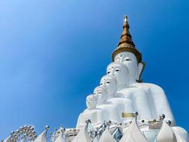 The big white Buddha five statue,Phetchabun is one of the top Thailand famous temples with a huge five white jade buddhas layered statue,Wat Phra That Pha Kaew, Phetchabun,Five white Buddha statue. photo