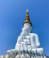 The big white Buddha five statue,Phetchabun is one of the top Thailand famous temples with a huge five white jade buddhas layered statue,Wat Phra That Pha Kaew, Phetchabun,Five white Buddha statue. photo