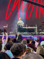 Captivating live performance by Sirotkin at the STEREOLETO Festival in Saint Petersburg, Russia, on June 15, 2024. The stage was alive with vibrant lights, energetic music, and an enthusiastic crowd. photo