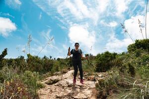 Hiker descending the mountain with enthusiasm, after having walked and contemplated all its beautiful scenery. photo