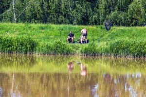 Nitra, Slovakia - 05.27.2024 Fishermen on the banks of the Nitra river. photo
