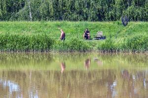 Nitra, Slovakia - 05.27.2024 Fishermen on the banks of the Nitra river. photo