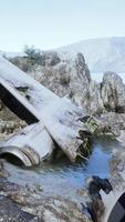 Decrepit airplane on jagged island shoreline video