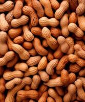 Peanuts heap background, top view, close up texture photo