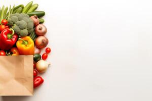 Paper bag with fresh vegetables isolated on white background with copy space, top view photo