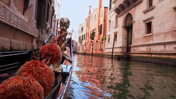Driving with the Gondola through a small Venezian canal. Beautiful gondola and gondolier driving through the old Venetian channel. First person view. video