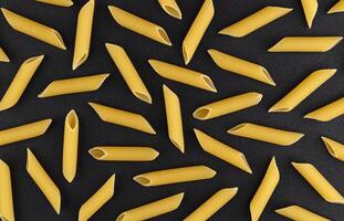 Penne rigate pasta pattern on black background, top view, flat lay texture photo