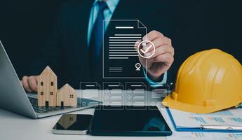 Architect or engineer Checking the list of documents and approving the project, Approved Buildings Permit concept with approved residential building project, Construction project inspection. photo