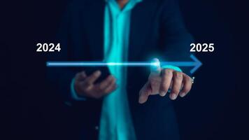 Start new business and new life, Businessman touch on virtual bar status to change from 2024 to 2025, Countdown of merry Christmas and happy new year by technology concept, New year's start-up. photo