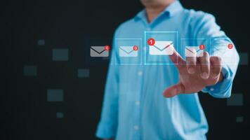 Online marketing, data link tech, Online communication, Businessman holding smartphone and touching with virtual icon white newsletter for electronic mail or E-mail with notification alert. photo