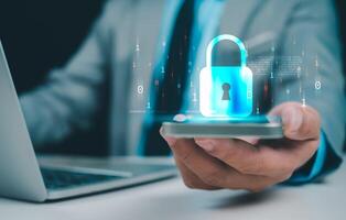 Businessman working on phone and computer online showing protection icons cyber espionage, Represents the code protection, Security concept and communication technology. photo