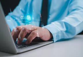 Businessman working on tablet and computer online showing protection icons cyber espionage, Represents the code protection, Security concept and communication technology. photo