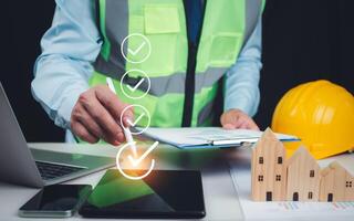 Architect or engineer Checking the list of documents and approving the project, Approved Buildings Permit concept with approved residential building project, Construction project inspection. photo