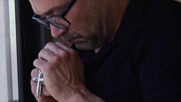 Man is Holding Christian Jesus Religious Symbol Cross for Pray video