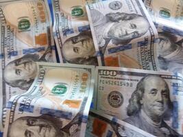A bunch of dollar bills with different faces on them.Concept of wealth and prosperity background photo