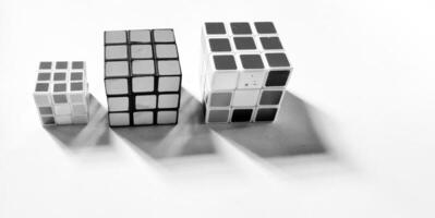 CENTRAL JAVA, INDONESIA. April 25th, 2024 - Black and white photo with an abstract photo concept. A portrait of three Rubik's cubes photographed by giving a shadow effect to the object.