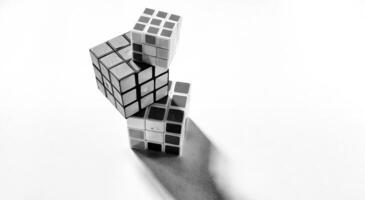 CENTRAL JAVA, INDONESIA. April 25th, 2024 - Black and white photo with an abstract photo concept. High angle view of three Rubik's cubes photographed by giving a shadow effect to the object.