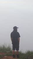 A Man Enjoying the Morning Atmosphere on Arang Hill, Gorontalo photo