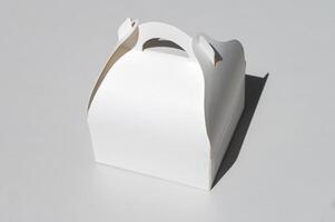 White cardboard box for a takeaway cake, highlighted on a white background with a clipping outline photo