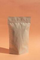 Layout of a clean paper kraft zip lock package on an orange background. photo