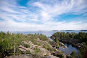 Sheer cliffs on Ladoga skerries. Granite island of Sortavaly in summer under a blue sky photo