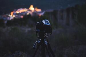 Digital camera placed on tripod, capturing the Andalusian medieval city of Quesada in mountains Sierra de Cazorla at dawn. Blurred mountains on background. Travel photography. World photography Day photo