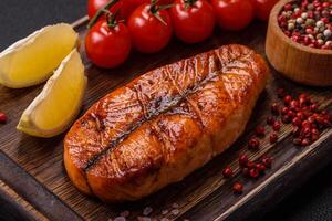Fresh cooked delicious salmon steak with spices and herbs photo