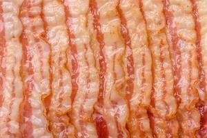 Delicious bacon in the form of slices with salt, spices and herbs photo