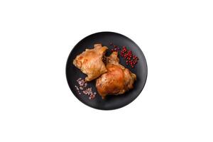 Delicious juicy chicken thighs baked on the grill with salt photo