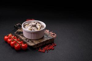 Boiled chicken hearts cut into slices with onions and cream sauce photo