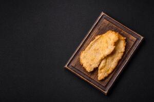Delicious juicy chicken chops in batter with salt, spices and herbs photo