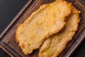 Delicious juicy chicken chops in batter with salt, spices and herbs photo