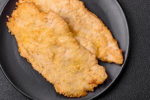 Delicious juicy chicken chops in batter with salt, spices and herbs photo