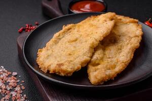 Delicious juicy chicken chops in batter with salt, spices and herbs photo