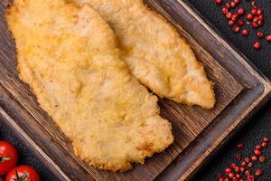 Delicious juicy chicken chops in batter with salt, spices and herbs photo