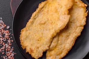 Delicious juicy chicken chops in batter with salt, spices and herbs photo