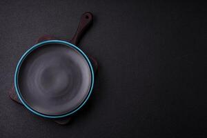 Empty ceramic round plate on dark textured concrete background photo
