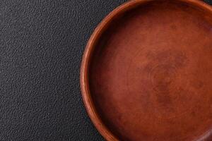Empty ceramic round plate on dark textured concrete background photo
