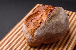 A loaf of brown bread with grains of cereals photo