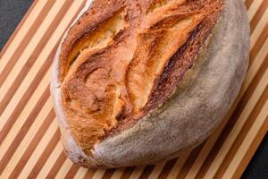 A loaf of brown bread with grains of cereals photo