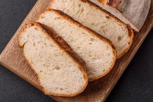 A loaf of brown bread with grains of cereals photo