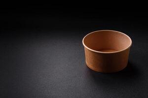 Empty ceramic round plate on dark textured concrete background photo