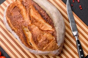 A loaf of brown bread with grains of cereals photo