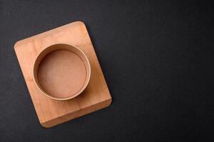 Empty ceramic round plate on dark textured concrete background photo