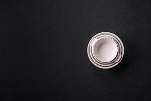 Beautiful empty white ceramic gravy boat on a concrete background photo