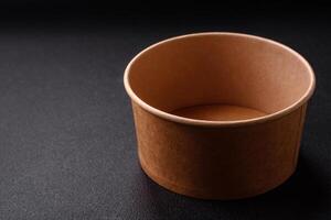 Empty ceramic round plate on dark textured concrete background photo