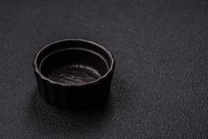 Beautiful empty white ceramic gravy boat on a concrete background photo