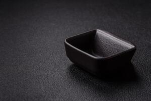 Beautiful empty white ceramic gravy boat on a concrete background photo