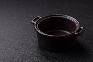 Beautiful empty white ceramic gravy boat on a concrete background photo